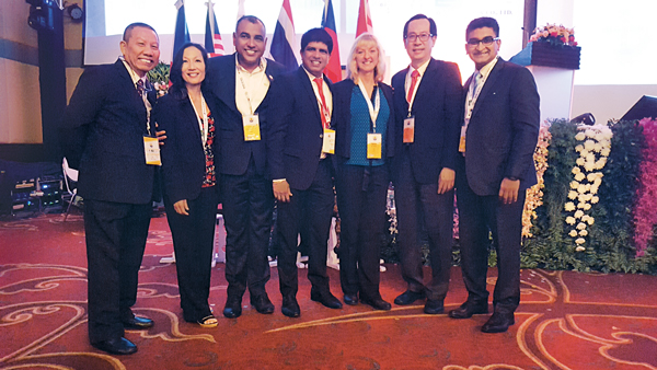 Dr. Miller, third from right, poses with several other FAOPMA conference presenters, including friend and fellow UF alumna Dr. Faith Oi (second from left). (Photo: Dr. Dini Miller)